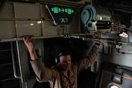 Tech. Sgt. Joshua B. Wilberg, a C-17 Globemaster III loadmaster assigned to the 816th Expeditionary Airlift Squadron in Southwest Asia, talks with a passenger during a airlift mission bound for Afghanistan, Feb. 1, 2010. Loadmasters plan cargo and passenger placement within permissible center of gravity limits of their respective aircraft. The aircrew later loaded the aircraft at Bagram Air Base, Afghanistan, and completed a combat airdrop over two seperate drop zones.  (U.S. Air Force photo/Staff Sgt. Manuel J. Martinez/released)

