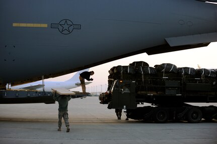 Staff Sgt. Chris Rapp, a C-17 Globemaster III loadmaster assigned to the 816th Expeditionary Airlift Squadron, guides a cargo-loader driver toward the aircraft's ramp Feb. 1, 2010, at Bagram Air Base, Afghanistan. Airmen and Soldiers loaded forty pallets of food and water to be air-dropped to U.S. and Coalition forces in remote areas of Afghanistan. (U.S. Air Force photo/Staff Sgt. Manuel J. Martinez/released)

