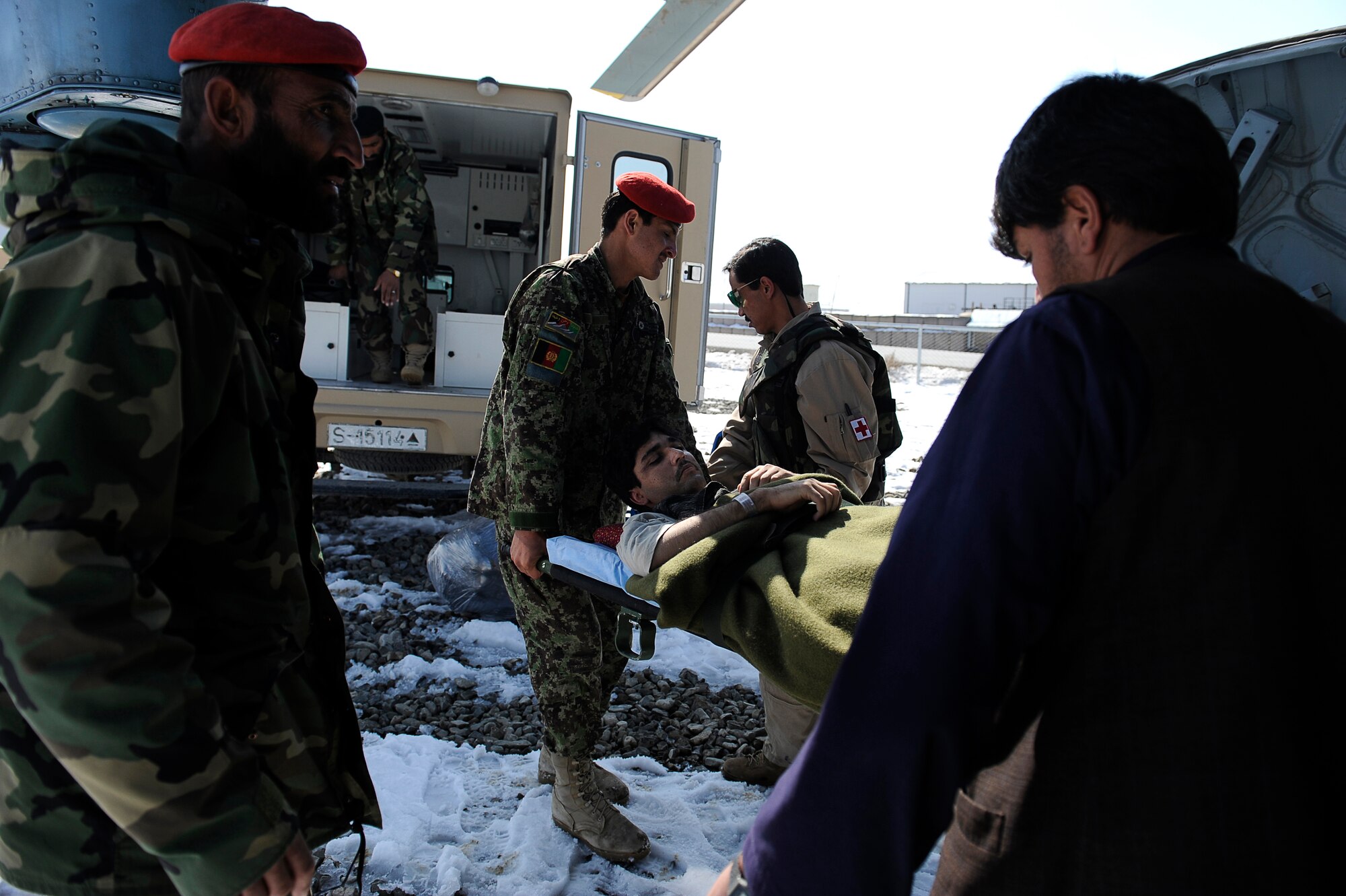 BAGRAM AIRFIELD, Afghanistan--Afghan Sgt. 1st Class Ghulam Sakhi, a flight medic with the 438th Air Expeditionary Advisory Group/Combined Air Power Transition Force, and soldiers from the Afghan National Army unload an injured soldier from a Mi-17 used for rotary wing medical evacuation missions, Feb. 3, 2010. This rotary wing medevac is the first of its kind in Afghanistan, where a combined Afghan and U.S. crew takes Afghans from coalition medical facilities and returns them to Afghan facilities. (U.S. Air Force photo by/ Tech. Sgt. Jeromy K. Cross/released)