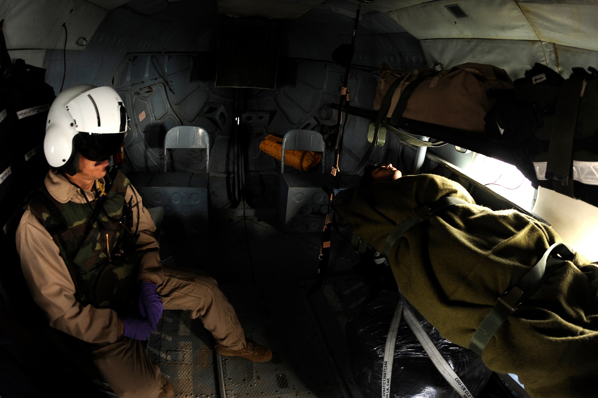 BAGRAM AIRFIELD, Afghanistan--Afghan Sgt.1st Class Ghulam Sakhi, flight medic with the 438th Air Expeditionary Advisory Group/Combined Air Power Task Force, looks after an injured Afghan soldier on a Mi-17 used for rotary wing medical evacuation missions, Feb. 3, 2010. This rotary wing medevac is the first of its kind in Afghanistan, where a combined Afghan and U.S. crew takes Afghans from coalition medical facilities and returns them to Afghan facilities. (U.S. Air Force photo by/ Tech. Sgt. Jeromy K. Cross/released)