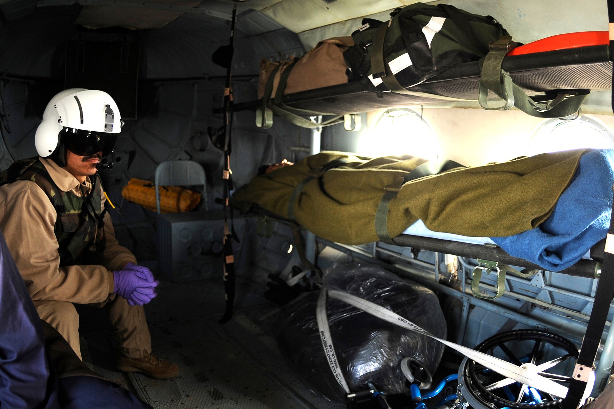 BAGRAM AIRFIELD, Afghanistan--Afghan Sgt. 1st Class Ghulam Sakhi, flight medic with the 438th Air Expeditionary Advisory Group/Combined Air Power Task Force, looks after an injured Afghan soldier on a Mi-17 used for rotary wing medical evacuation missions Feb. 3, 2010. This rotary wing medevac is the first of its kind in Afghanistan, where a combined Afghan and U.S. crew takes Afghans from coalition medical facilities and returns them to Afghan facilities. (U.S. Air Force photo by/ Tech. Sgt. Jeromy K. Cross/released)