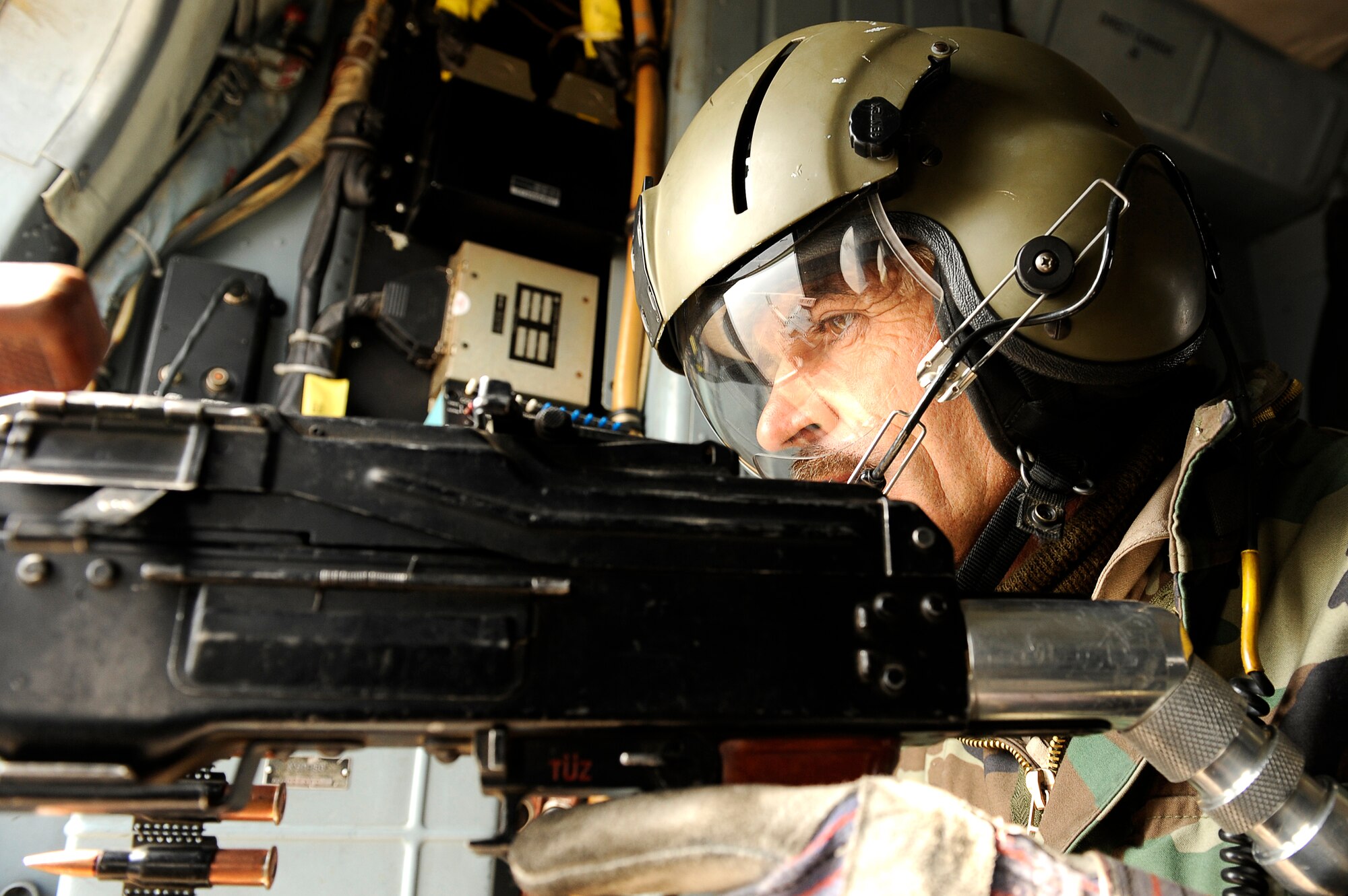 BAGRAM AIRFIELD, Afghanistan--An Afghan solider with the 438th Air Expeditionary Advisory Group/Combined Air Power Task Force, serves as the door gunner on a Mi-17 used for rotary wing medical evacuation missions, Feb. 3, 2010. This rotary wing medevac is the first of its kind in Afghanistan, where a combined Afghan and U.S. crew takes Afghans from coalition medical facilities and returns them to Afghan facilities. (U.S. Air Force photo by/ Tech. Sgt. Jeromy K. Cross/released)