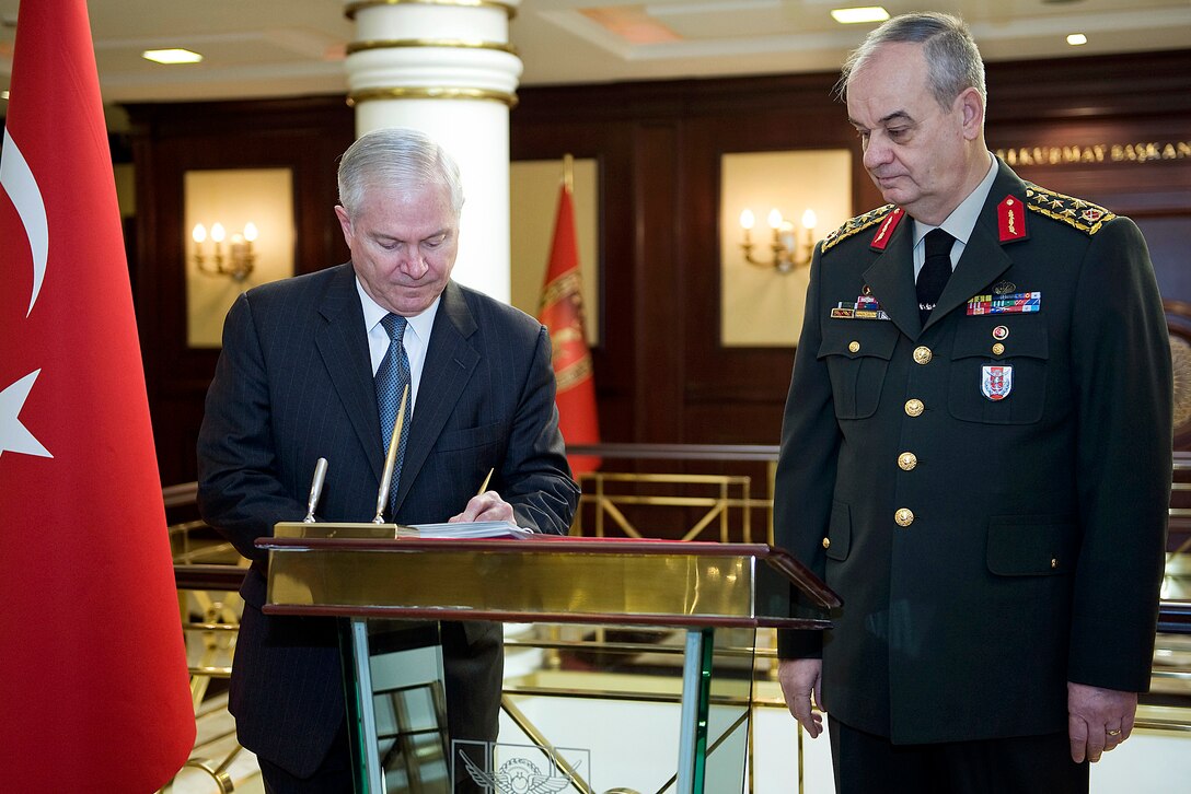 U.S. Defense Secretary Robert M. Gates signs the guest book before meeting with Turkish Chief of General Staff Gen. Ilker Basbug, right, in Ankara, Turkey, Feb. 6, 2010.