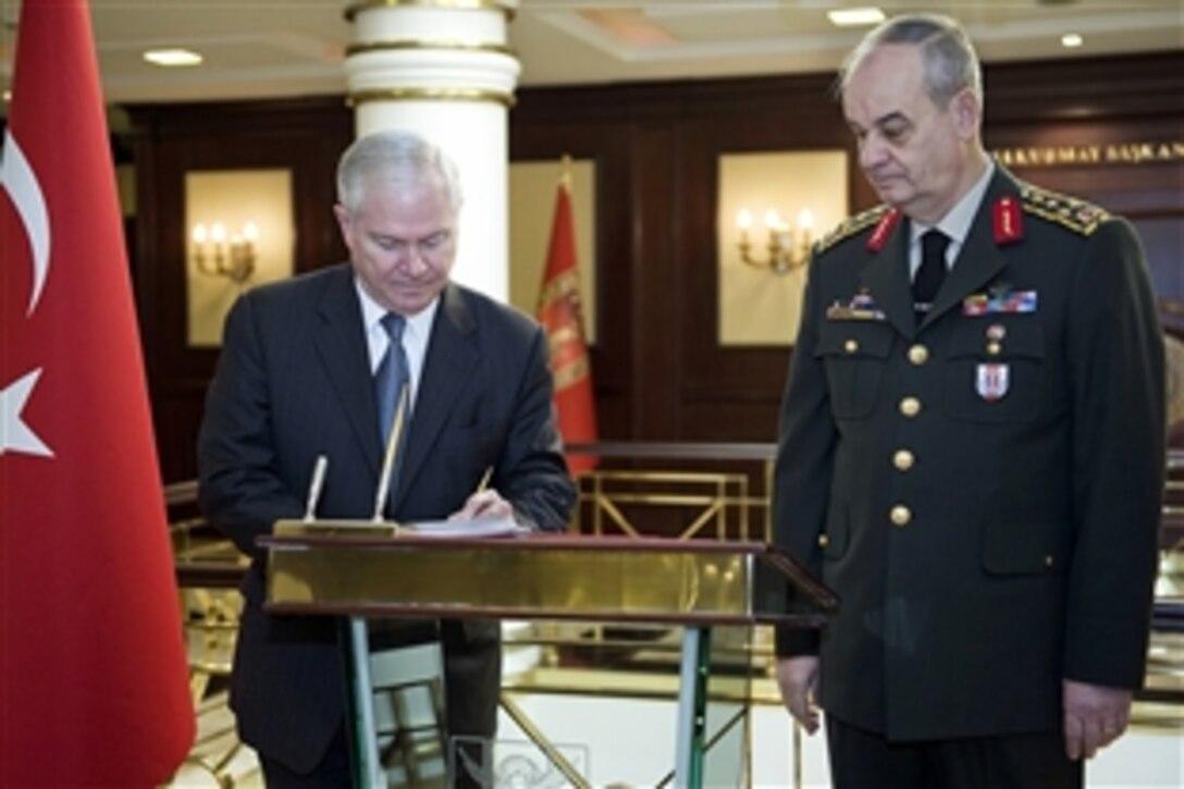 U.S. Defense Secretary Robert M. Gates signs the guest book before meeting with Turkish Chief of General Staff Gen. Ilker Basbug, right, in Ankara, Turkey, Feb. 6, 2010.  