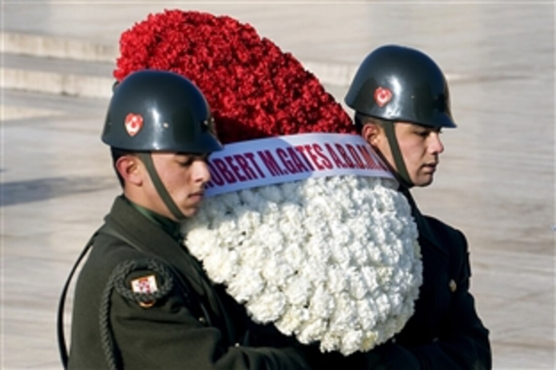 Members of the Turkish military carry a wreath with U.S. Defense Secretary Robert M. Gates' name as he prepares to lay a wreath at  Anitkabir Mausoleum, named after the founder of the Republic of Turkey Mustafa Kemal Ataturk, in Ankara, Turkey, Feb. 6, 2010.