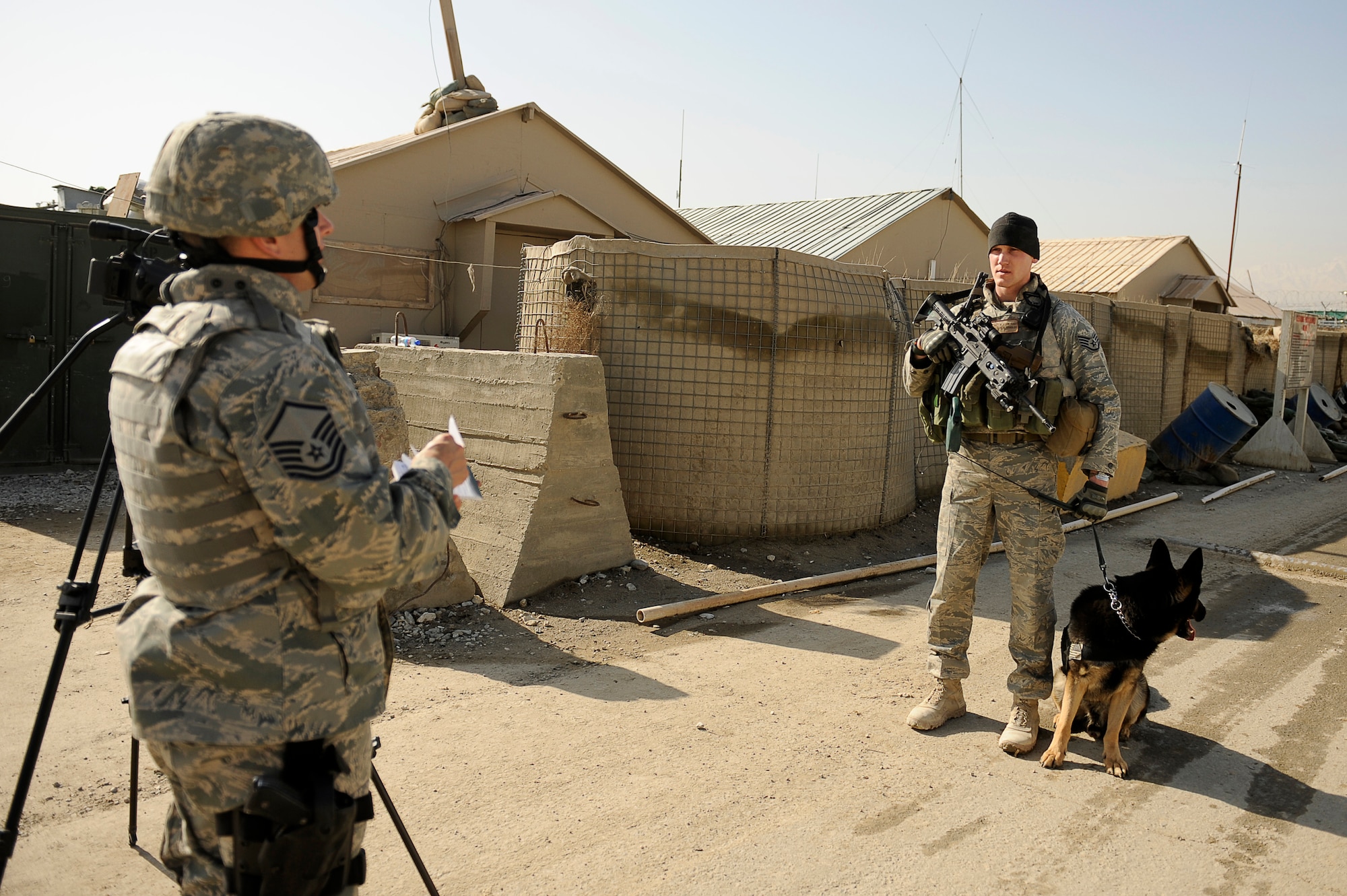 BAGRAM AIRFIELD, Afghanistan--U.S. Air Force Staff Sgt. Mitchell Stein and Artus, a military working dog, 455th Expeditionary Security Forces Squadron, get interviewed by Master Sgt. Sebastiano Marino, 455th Air Expeditionary Wing, Public Affairs, at Bagram Airfield, Feb. 2, 2010. Sgt. Stein is from Crescent City, Ill., he and Artus are deployed from Spangdahlem Air Base, Germany. Sgt. Marino is deployed from Vandenberg, Air Force Base, Calif. (U.S. Air Force photo by/ Tech. Sgt. Jeromy K. Cross/released)