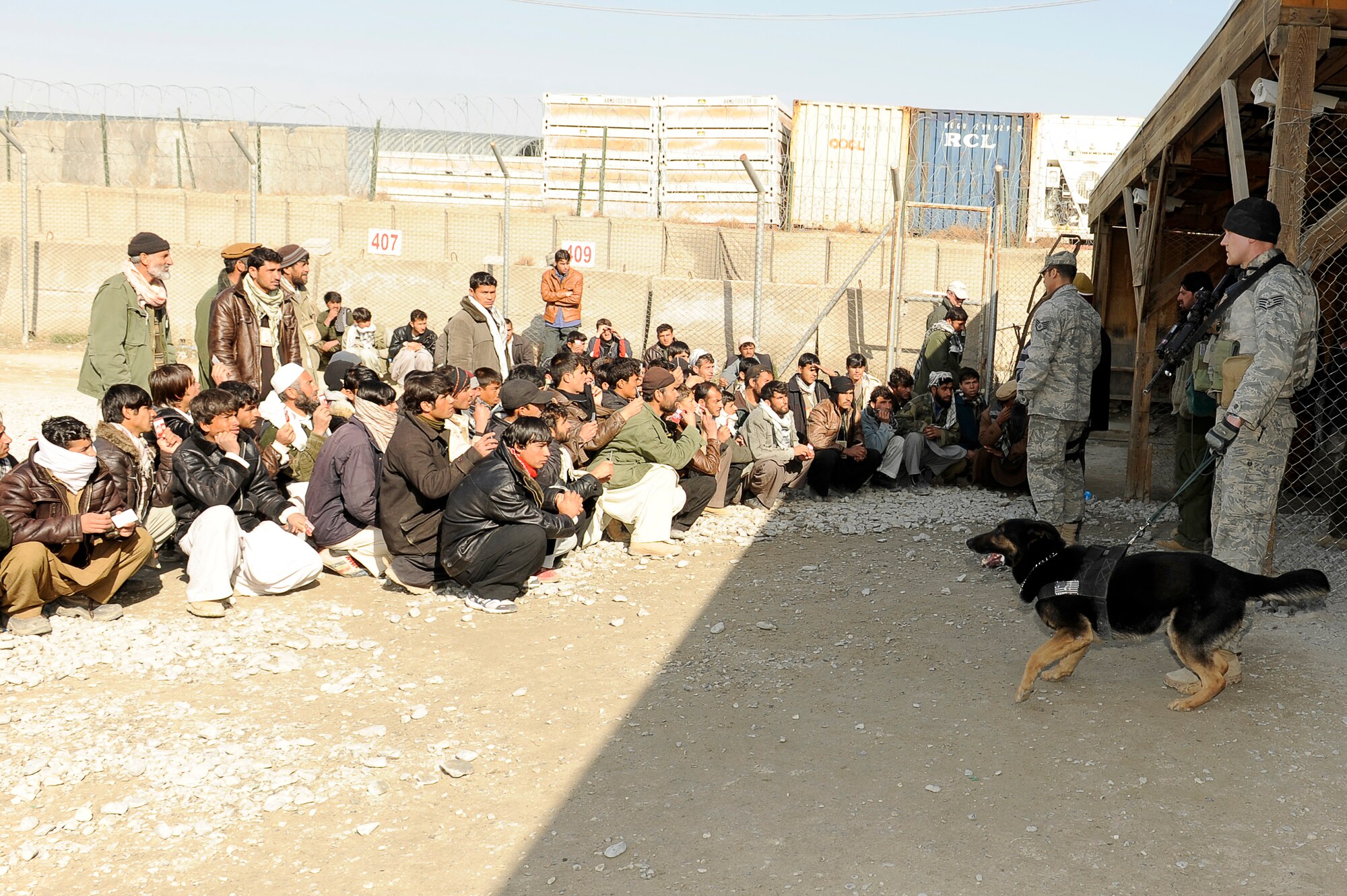 BAGRAM AIRFIELD, Afghanistan--U.S. Air Force Staff Sgt. Mitchell Stein and Artus, a military working dog, 455th Expeditionary Security Forces Squadron act as crowd control at an entry control point on Bagram Airfield, Feb. 2, 2010. Sgt. Stein is from Crescent City, Ill., he and Artus are deployed from Spangdahlem Air Base, Germany. (U.S. Air Force photo by/ Tech. Sgt. Jeromy K. Cross/released)