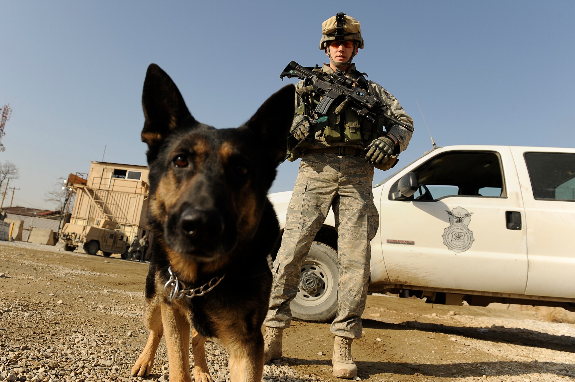 BAGRAM AIRFIELD, Afghanistan--U.S. Air Force Staff Sgt. Mitchell Stein and Artus, a military working dog, 455th Expeditionary Security Forces Squadron, patrol at one of Bagram's entry control points, Feb. 2, 2010. Sgt. Stein is from Crescent City, Ill., he and Artus are deployed from Spangdahlem Air Base, Germany. (U.S. Air Force photo by/ Tech. Sgt. Jeromy K. Cross/released)