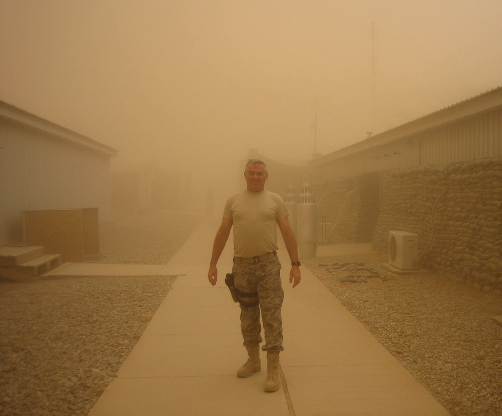 KIRKUK AIR BASE, Iraq -- Maj. Raymond Schierhoff, 446th Security Forces Squadron commander, Joint Base Lewis-McChord, McChord Field, Wash., braves a fierce sandstorm while recently deployed here in support of Operation Iraqi Freedom. Twenty-three Airmen deployed from the squadron, making this the largest contingent of 446th SFS Reservists deployed at one time. (Courtesy photo)