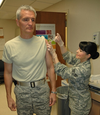 Senior Airman Sheryl Sorensen, 315th Aerospace Medical Squadron, administers the H1N1 influenza vaccine to Col. Steven Chapman, 315th Airlift Wing commander, Saturday, Feb. 6 here at Charleston Air Force Base. (US Air Force photo by Senior Airman Dani Pacheco Shea/Released)