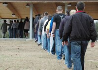 A line of 32 new Air Force Reserve recruits march before forming up for a lesson on facing movements Feb. 6 at Duke Field.  Tech. Sgt. Raul Lopez and his wife, Master. Sgt. Tiffany Lopez, 96th Force Support Squadron, both former active-duty military training instructors at Lackland AFB, Texas, volunteered their time to help new reserve recruits prepare for basic training during the drill weekend here.  The husband and wife team spent four years instructing new trainees at Lackland graduating 25 flights from Basic Military Training.  (U.S. Air Force photo/Staff Sgt. Jon McCallum) 