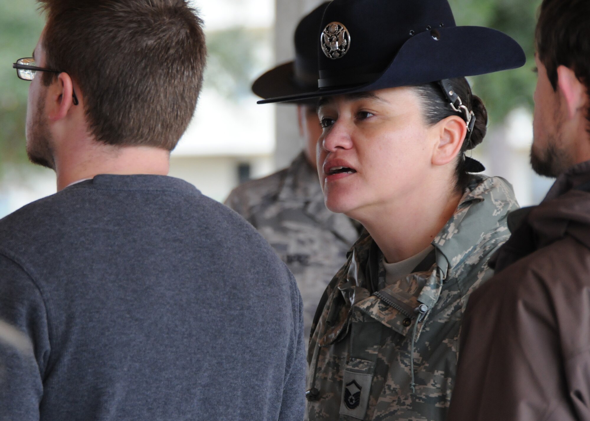 Master. Sgt. Tiffany Lopez, 96th Force Support Squadron, corrects a new Air Force Reserve recruit Feb. 6 at Duke Field.  Sergeant Lopez and her husband, Tech. Sgt. Raul Lopez, 96th Logistics Readiness Squadron, both former active-duty military training instructors at Lackland AFB, Texas, volunteered their time to help new reserve recruits prepare for basic training during the drill weekend here.  The husband and wife team spent four years instructing new trainees at Lackland graduating 25 flights from Basic Military Training.  (U.S. Air Force photo/Tech. Sgt. Samuel King Jr.) 
