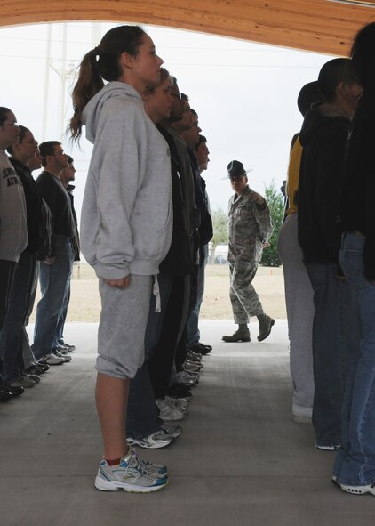 Tech. Sgt. Raul Lopez, 96th Logistics Readiness Squadron, looks over his formation of new Air Force Reserve recruits Feb. 6 at Duke Field.  Sergeant Lopez and his wife, Master. Sgt. Tiffany Lopez, 96th Force Support Squadron, both former active-duty military training instructors at Lackland AFB, Texas, volunteered their time to help new reserve recruits prepare for basic training during the drill weekend here.  The husband and wife team spent four years instructing new trainees at Lackland, graduating 25 flights from Basic Military Training.  (U.S. Air Force photo/Tech. Sgt. Samuel King Jr.) 