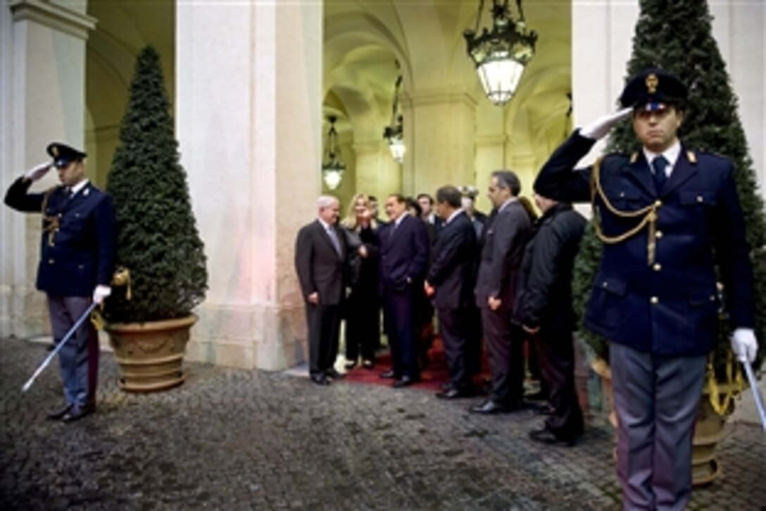 U.S. Defense Secretary Robert M. Gates speaks with Italian Prime Minister Silvio Berlusconi as he departs Palazzo Chigi in Rome, Feb. 7, 2010.