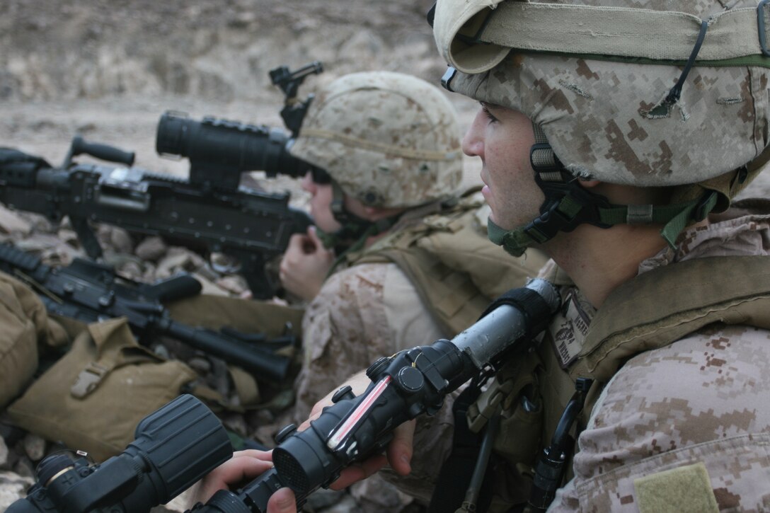 Corporal Aaron McCrea, a San Jose, Calif., native, and other Marines from Weapons Company, Battalion Landing Team 2/4, 11th Marine Expeditionary Unit, provide security while others offload gear from a CH-53E Super Stallion helicopter here Feb 7.  Weapons Company Marines conducted mortar live-fire and coordinated supporting fires with fixed and rotary wing aircraft from Marine Medium Helicopter Squadron 166 (Reinforced).