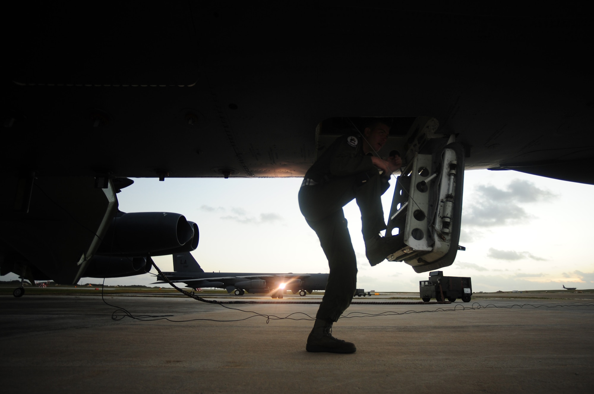 U.S. Air Force 1st Lt. Jim Lewis, a B-52 Stratofortress navigator assigned to the 20th Expeditionary Bomb Squadron, Barksdale Air Force Base, La., climbs aboard a B-52 aircraft prior to a mission in support of Exercise Cope North at Andersen AFB, Guam, Feb. 9, 2010. The United States Air Force and the Japanese Air Self-Defense Force conduct Cope North annually to increase combat readiness and interoperability, concentrating on coordination and evaluation of air tactics, techniques and procedures.  The ability for both nations to work together increases their preparedness to support real-world contingencies.  (U.S. Air Force photo by Staff Sgt. Jacob N. Bailey)




