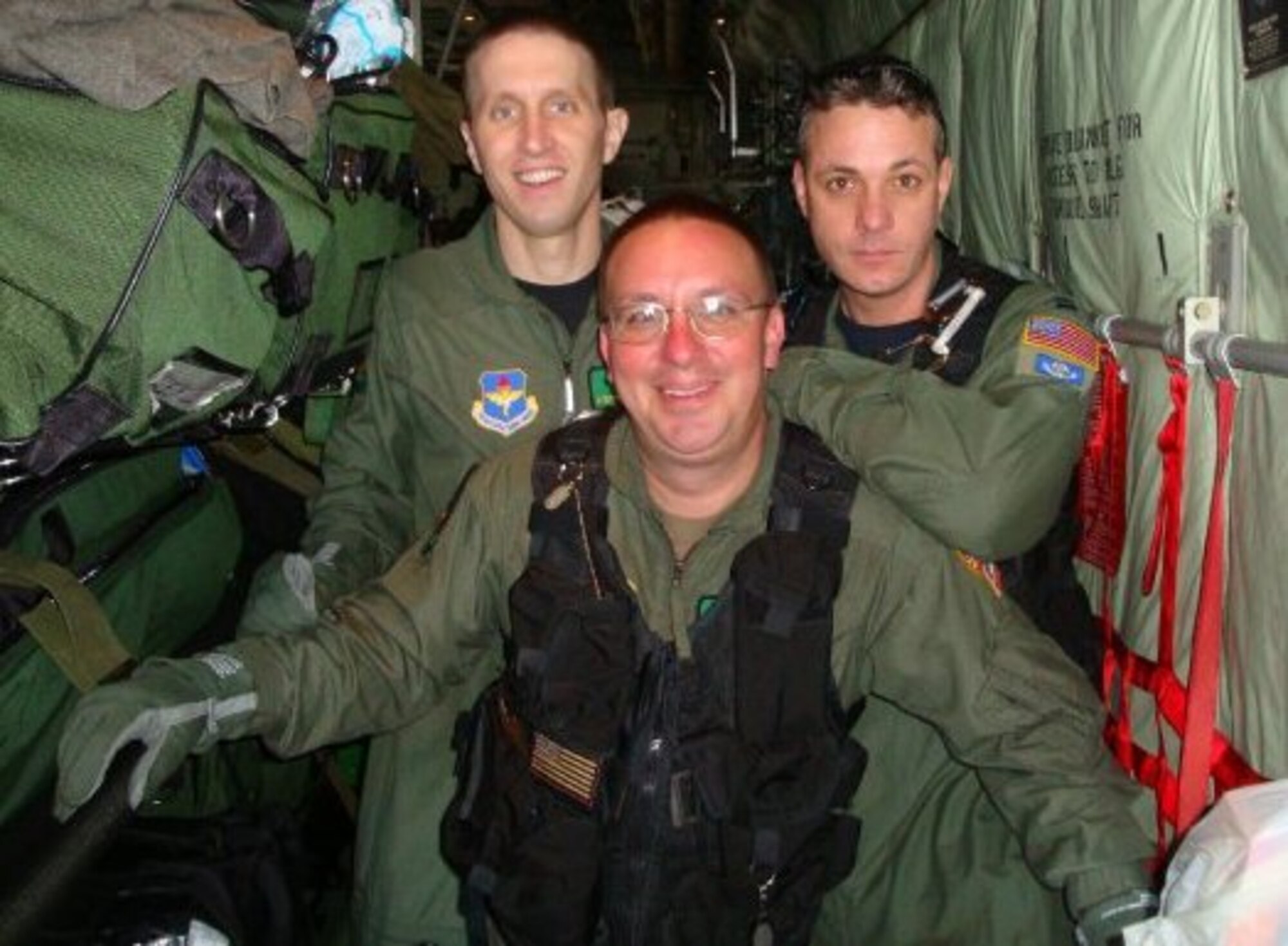 Maj. (Dr.) Stephen Boskovich, left, Tech. Sgt. Pakula, center, and Capt. John Michael Fowler pause for a photo aboard a C-130 Hercules Feb. 8. Two Critical Care Air Transport Teams from the 81st Medical Operations Squadron at Keesler AFB, are assisting in the airlift and treatment of Haitian earthquake victims to hospitals. (Courtesy Photo) 