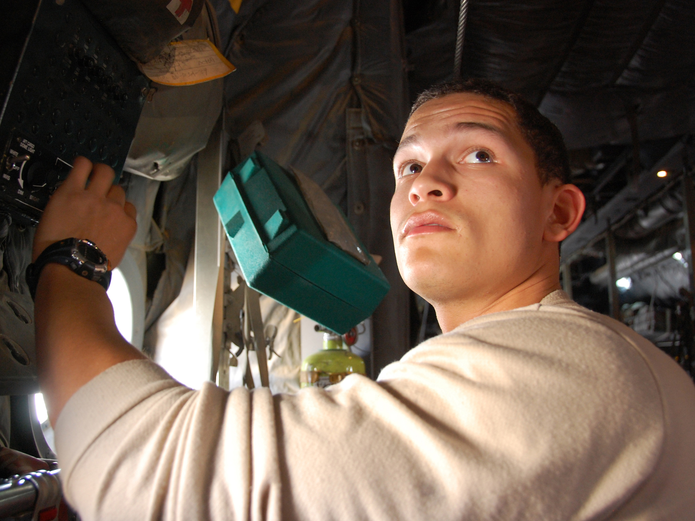 Airman makes sure cargo dome lights in a C130 Hercules work