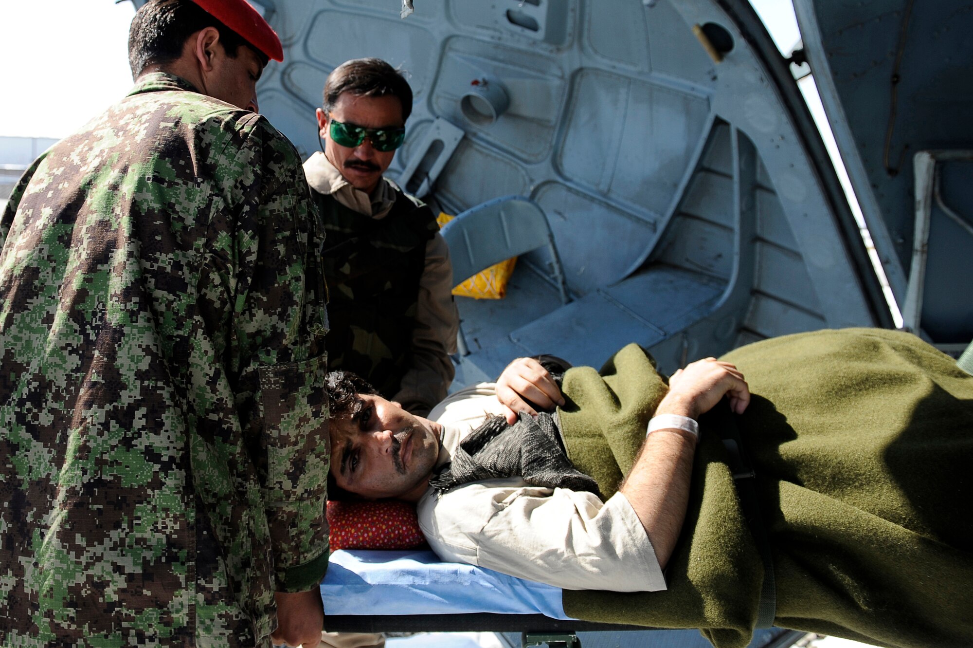 Afghanistan National Army Air Corp Sgt. 1st Class Ghulam Sakhi and a soldier from the Afghan National Army unload an injured soldier from a Mi-17 helicopter Feb. 3, 2010, at Bagram Airfield, Afghanistan. Sergeant Sakhi is a flight medic with the 438th Air Expeditionary Advisory Group/Combined Air Power Transition Force. (U.S. Air Force photo/Tech. Sgt. Jeromy K. Cross)