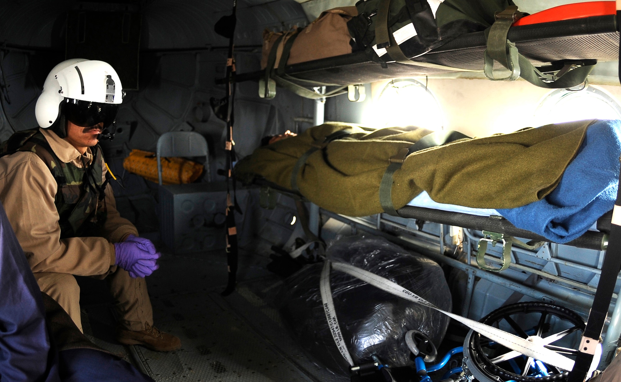 Afghanistan National Army Air Corp Sgt. 1st Class Ghulam Sakhi looks after an injured Afghan soldier on a Mi-17 helicopter Feb. 3, 2010, at Bagram Airfield, Afghanistan. Sergeant Sakhi is a flight medic with the 438th Air Expeditionary Advisory Group/Combined Air Power Transition Force. (U.S. Air Force photo/Tech. Sgt. Jeromy K. Cross)