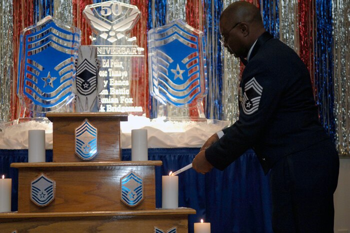 Chief Master Sgt. Kenneth Battle lights the senior master sergeant candle at the Annual Charleston Chief's Recognition Ceremony held at the Charleston Club Feb. 6. Chief Battle was one of six Airmen selected for promotion at Joint Base Charleston to the rank of chief master sergeant. Chief Battle is with the 315th Maintenance Squadron. (U.S. Air Force Photo/Airman 1st Class Lauren Main)