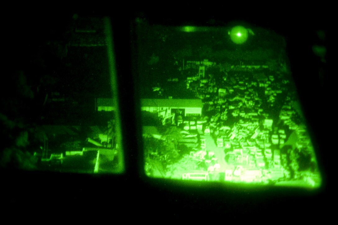 The Haitian landscape passes by as a 139th Airlift Wing, C-130 and it's crew fly into Port-Au-Prince on a relief mission on the night of 6 February, 2010. (U.S. Air Force photo by Master Sgt. Shannon Bond/Released)