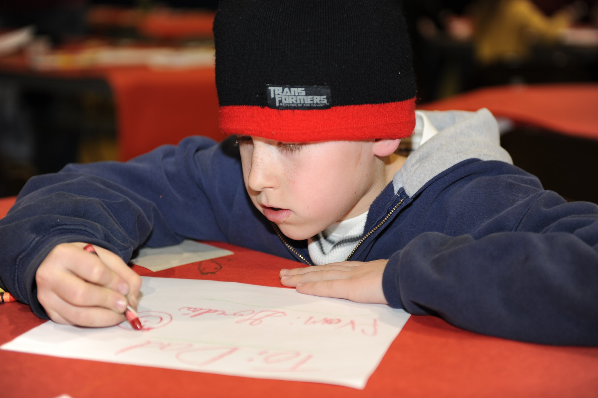 Gordie Straker, son of Tech. Sgt. Eric Straker, 28th Aircraft Maintenance Squadron weapons expediter currently deployed, colors a picture for his dad, during Sweetheart Bingo on Feb 5. The Airman and Family Readiness Center sponsored this event for family members of Airmen deployed or on remote assignments. The mission of the Ellsworth AFRC is to provide versatile and responsive foundations which  build readiness, retention and resiliency and lead to personal effectiveness.  (U.S. Air Force photo/Master Sgt. Loren J. Bonser)
