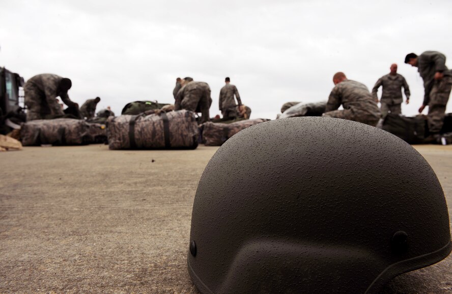 MOODY AIR FORCE BASE, Ga. -- Airmen from the 763rd Aircraft Maintenance Squadron at Nellis Air Force Base, Nev., find gear from their personal bags while waiting for a flight to Haiti here Feb. 2. Airmen from Moody and the 763rd AMXS will be providing humanitarian support. (U.S. Air Force photo by Airman 1st Class Joshua Green)