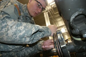 FORT EUSTIS, Va. -- 1-222nd Aviation Regiment Pfc. Brandon Lester, a Charlie Company student training to become a 15T Black Hawk repairer, removes a break assembly from a UH-60 landing gear simulator. (U.S. Army photo/Tetaun Moffett)