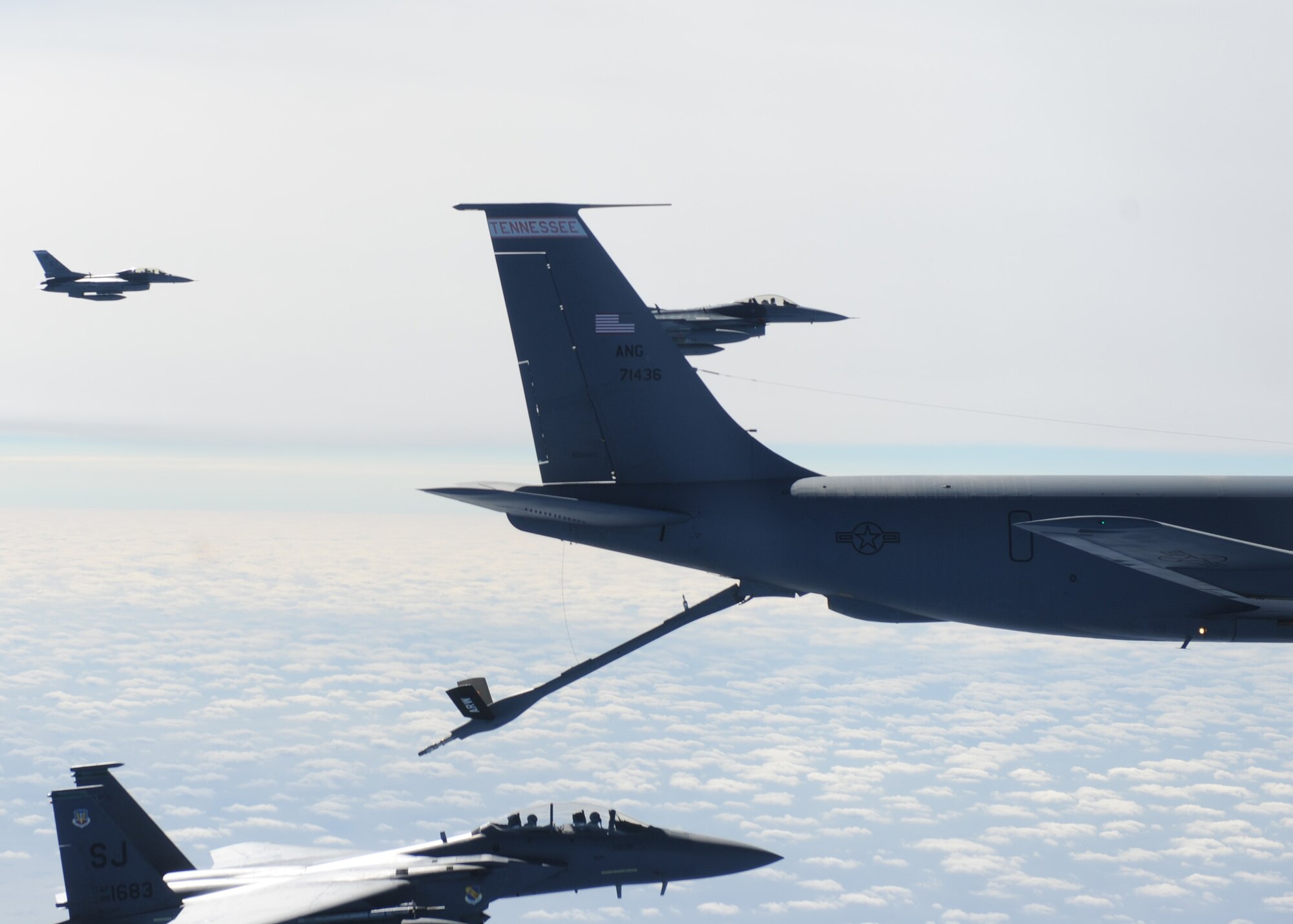 A 4th Fighter Wing F-15E Strike Eagle connects with a KC-135 Stratotanker from the 134th Air Reserve Wing for a refuel while 46th Test Wing F-16s stand by during a Combat Hammer mission Feb. 3.  Combat Hammer is an Air-to-Ground Weapons System Evaluation Program controlled by the 86th Fighter Weapons Squadron.  The F-15s from Seymour Johnson AFB, N.C., participated in the week-long evaluation dropping GPS and laser-guided weapons.  The WSEP was the first evaluation of Small Diameter Bombs at Eglin and first evaluation of Laser Joint Direct Attack Munitions in a Combat Hammer.   The WSEP program, run by the 53d Weapons Evaluation Group, is used to evaluate the effectiveness and suitability of combat air force weapon systems. The evaluations are accomplished during tactical deliveries of fighter, bomber and unmanned aerial system precision guided munitions, on realistic targets with air-to-air and surface-to-air defenses. For many of the aircrew participating in WSEP, it is the first time employing live weapons. This provides a level of combat experience many units face during combat.  (U.S. Air Force photo/Maj. Scott Alford.)
