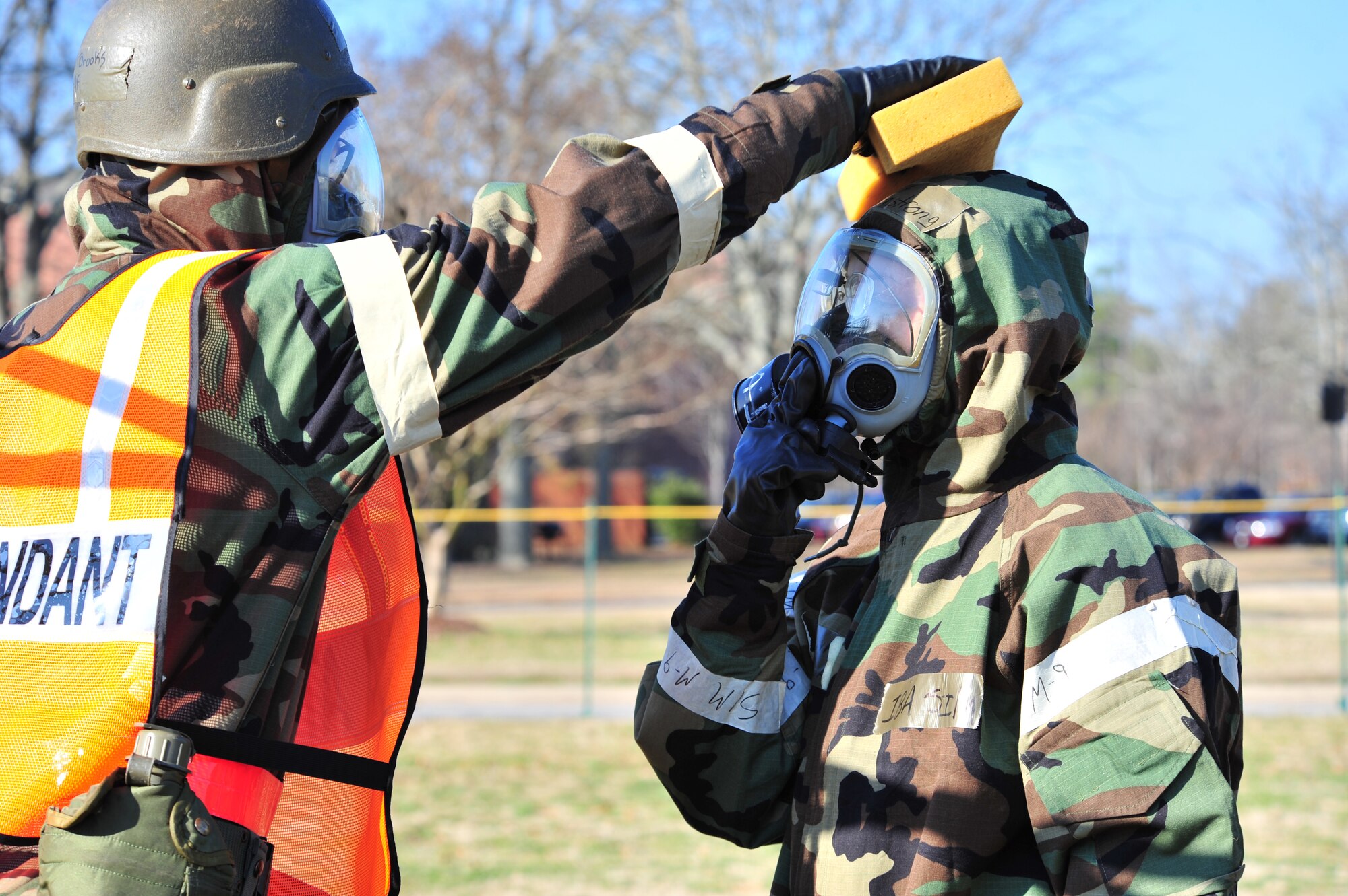 SHAW AIR FORCE BASE, S.C. -- Staff Sgt. Gena Armstrong, 20th Fighter Wing Public Affairs broadcaster, simulates getting her hood decontaminated during the phase II operational readiness exercise here Feb. 8. Airmen of the 20th Fighter Wing prepare for the exercise by practicing decontamination in full mission-oriented protective posture, or MOPP, gear. Shaw performs routine exercises throughout the year to ensure Airmen are ready for deployments. (U.S. Air Force photo/Airman 1st Class Amber E. N. Jacobs)