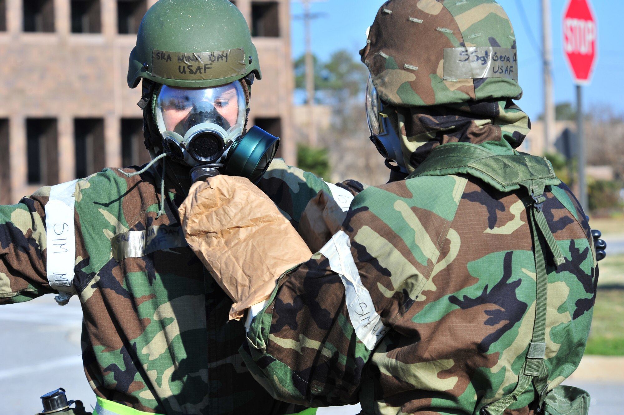 SHAW AIR FORCE BASE, S.C. -- Senior Airman Nina Day (left) and Staff Sgt. Gena Armstrong, Airmen of the 20th Fighter Wing, pat each other down in order to decontaminate their protective clothing during the phase II operational readiness exercise here Feb. 8. Airmen of the 20th Fighter Wing prepare for the exercise by practicing decontamination in full mission-oriented protective posture, or MOPP, gear. Shaw performs routine exercises throughout the year to ensure Airmen are ready for deployment. (U.S. Air Force photo/Airman 1st Class Amber E. N. Jacobs)