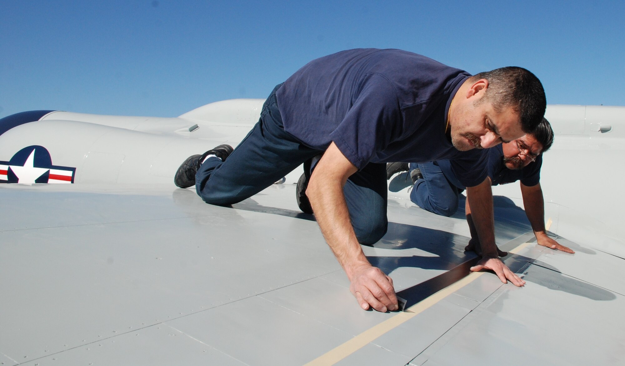 LAUGHLIN AIR FORCE BASE, Texas - Mario Constancio, left, and Juan A. Gonzalez,
47th Flying Training Wing aircraft maintenance corrosion controllers, put
the finishing touches on the newly restored U-2C on static display near the
front gate here.  Crews removed the faded, chipped paint and corrosion from
the aircraft by sanding the exterior.  They then repainted the entire
aircraft and applied new decals using masking tape as a guide.  They had
more than a dozen photographs of the aircraft with them to make sure they
restored the U-2C to its original form.  Laughlin's aircraft maintenance
crews work to restore planes on display here on an as-needed basis. (U.S.
Air Force photo by Tech. Sgt. Charlie Miller)
