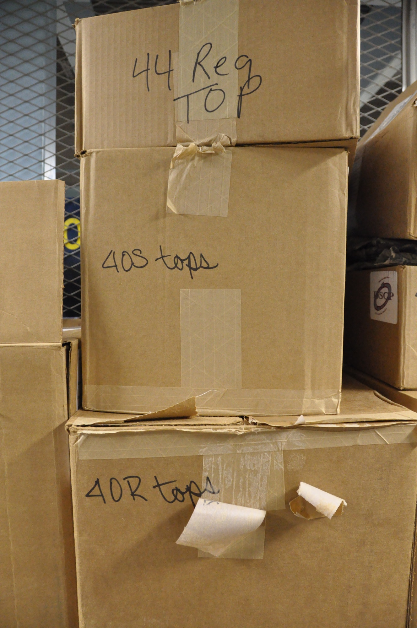 Boxes of ABU blouses awaiting pickup are stacked high in the supply warehouse of the 128th Air Refueling Wing. (US Air Force Photo by: SSgt Nathan Wallin)