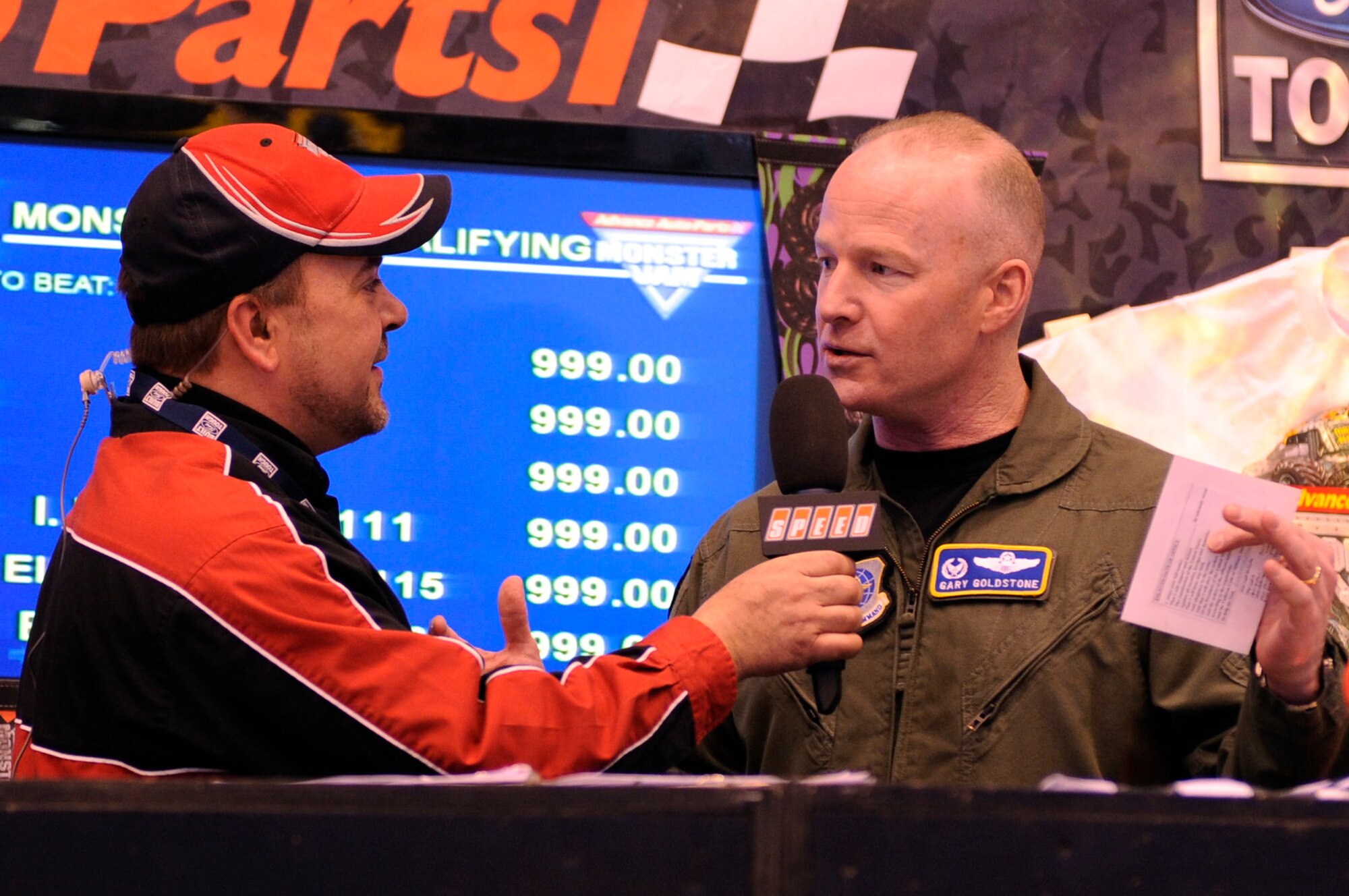 SCOTT AIR FORCE BASE, Ill -- Monster Jam announcer, Scott Douglas, interviews Col. Gary Goldstone, 375th Air Mobility Wing commander, Feb. 6th, 2010 at the Monster Jam event held in St. Louis, Mo.  Prior to the start of the event, Colonel Goldstone administered the oath of enlistment to members of the U.S. Air Force Delayed Entry Program.  All potential servicemembers enter the DEP for up to a year as inactive Reserves as they wait for a basic military training date so that it coincides with technical school availability, high school graduation, or to have more time to research the military. In addition to witnessing 38 individuals swear in, the crowd also watched as members of the Scott Air Force Base Honor Guard presented the colors.  (U.S. Air Force photo/ Senior Airman Wesley Farnsworth)