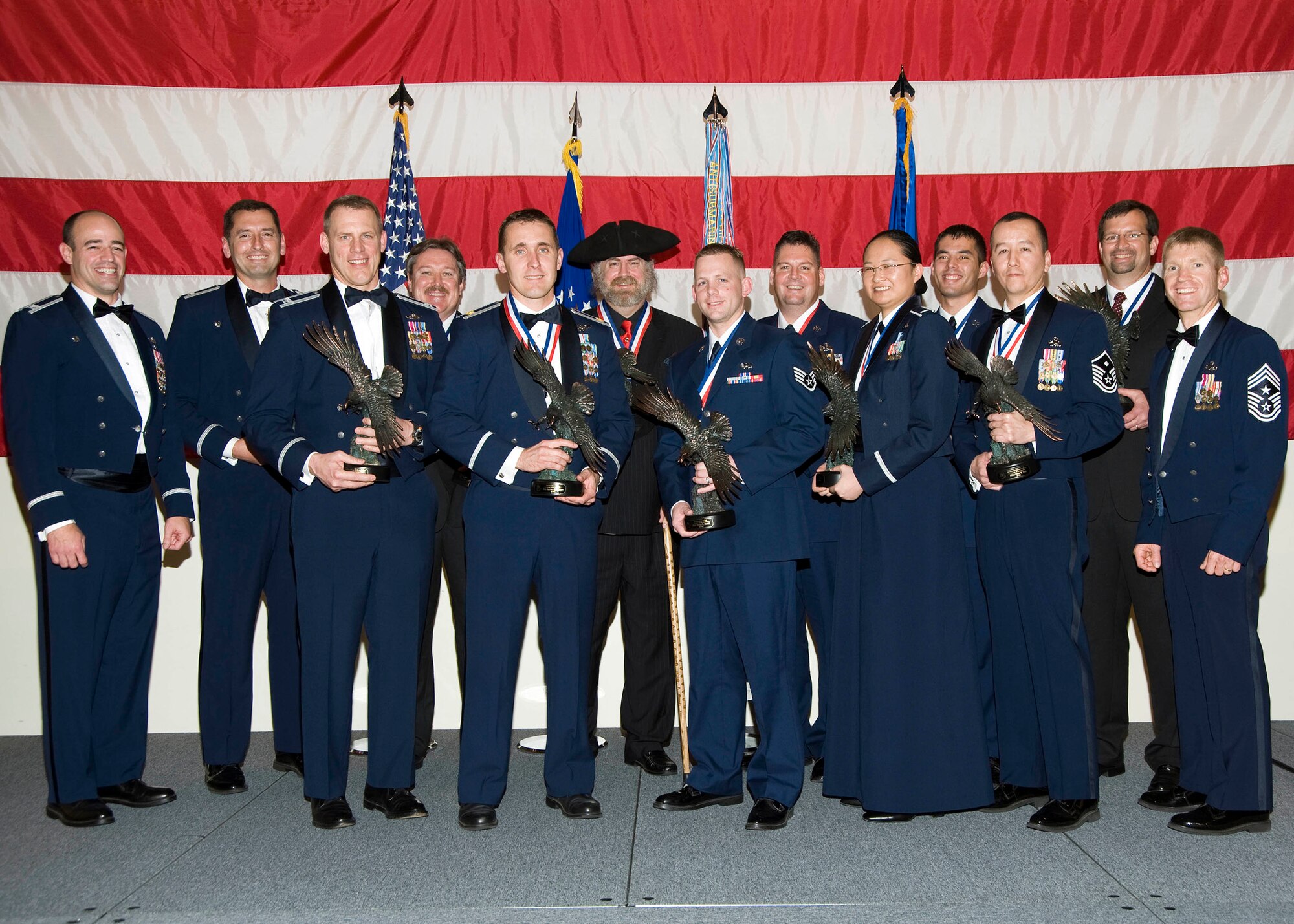 The 53rd Wing honored its annual award winners during a ceremony held Feb. 4. Col. Michael Gantt, 53rd Wing commander(far left) and Chief Master Sgt. William Harner, Wing command chief (far right) pose with this year’s winners. The winners include: Master Sgt. Gene W. Sing, 53rd Weapons Evaluation Group, first sergeant of the year; Airman 1st Class Joseph H. Eckert, 68th Electronic Warfare Squadron, airman of the year; Staff Sgt. Bryan S. Moore, 422 Test and Evaluation Squadron, NCO of the year; Master Sgt. Terry L. Wenger, 28th Test and Evaluation Squadron, senior NCO of the year; 1st Lt. Simone Shen, 453rd Electronic Warfare Squadron, CGO of the year; Maj. Jeffrey R. Elliott, 28th Test and Evaluation Squadron, FGO of the year; Carl D. Elderidge (not pictured), 53rd Training Systems Squadron, Civilian Category I; Elisa R. Flores (not pictured), 53rd Test and Evaluation Group, Civilian Category II; Richard D. Degraw, 85th Test and Evaluation Squadron, Civilian Category III; Roger L. Muse, 31st Test and Evaluation Squadron, Civilian Category IV; and Anthony L. Ordner, 28th Test and Evaluation Squadron, Civilian Category V. 
