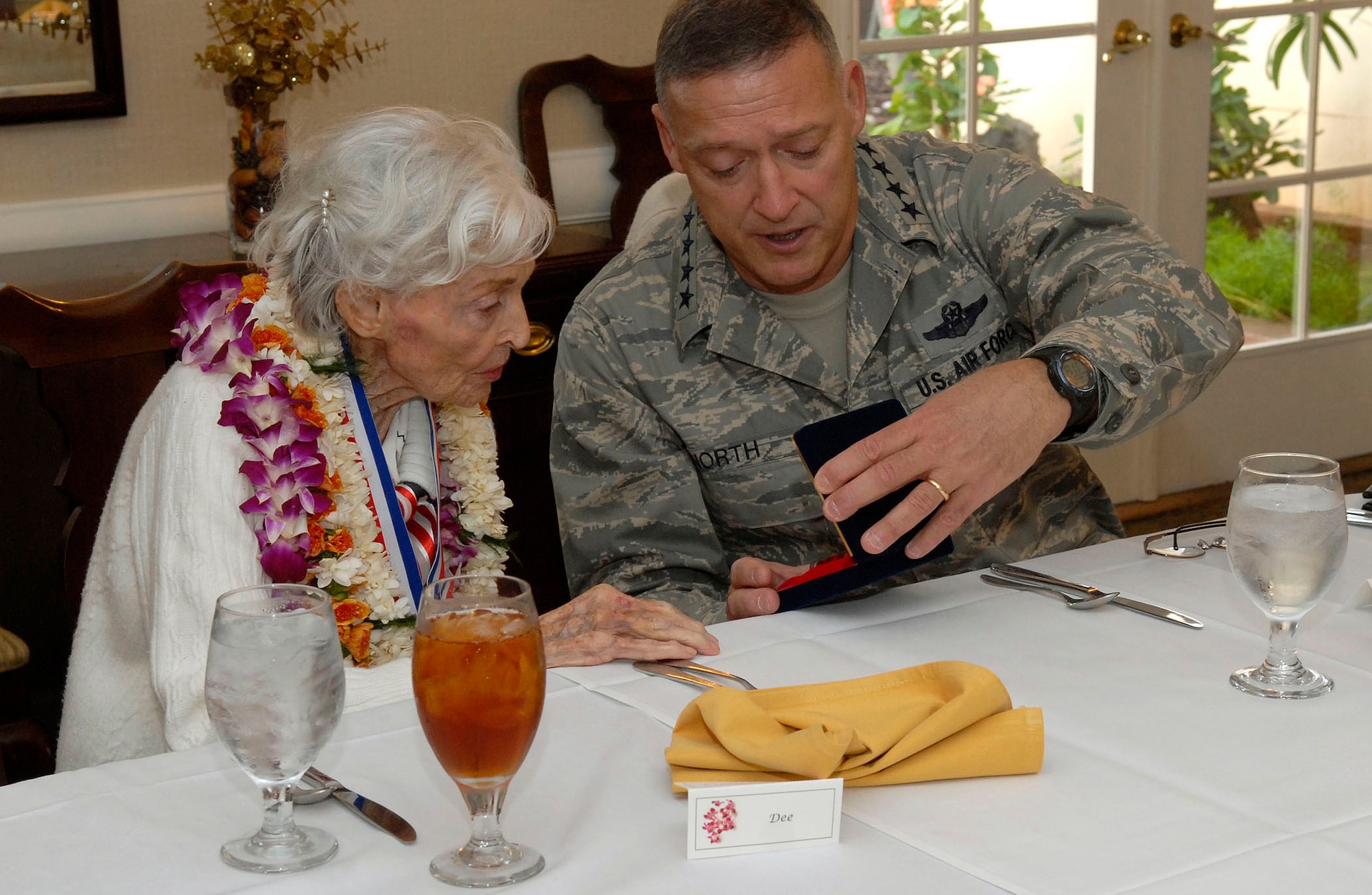 Gen. Gary North presents a gift to Doris Avery at a luncheon in her honor Feb. 5, 2010, at Joint Base Pearl Harbor Hickam, Hawaii. General North is the Pacific Air Forces commander. (U.S. Air Force photo/Tech. Sgt. Jerome S. Tayborn)