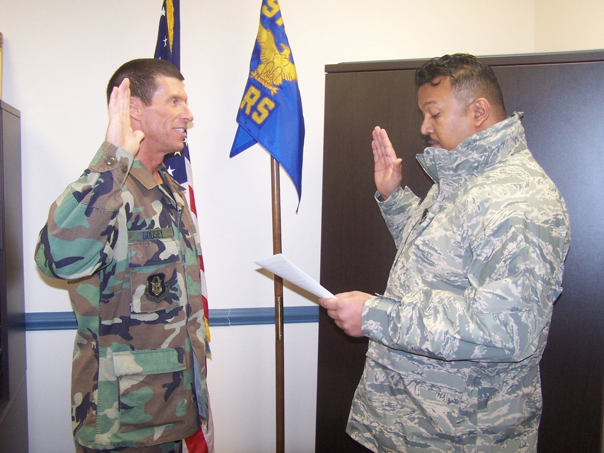 Master Sgt. Roger Godsey, a vehicle maintenance craftsman with the 916th Logistics Readiness Squadron, re-enlists with Capt. Neil Chandler, operations officer. (USAF courtesy photo)