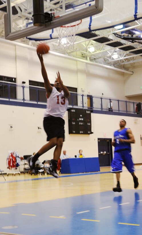 Matt Spriggs, 497th Intelligence, Surveillance and Reconnaissance Group, attempts a lay-up in an intramural basketball game against the Combat Targeting and Intelligence Group at the Shellbank Fitness Center Feb. 4. CTIG won the game 46-22. (U.S. Air Force photo/Airman 1st Class Jason J. Brown)