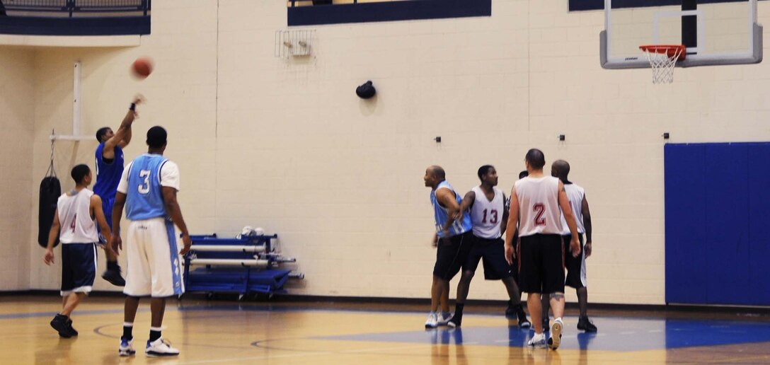 Drew Colen, Combat Targeting and Intelligence Group, attempts a three-pointer in an intramural basketball game against the 497th Intelligence, Surveillance and Reconnaissance Group at the Shellbank Fitness Center Feb. 4. CTIG won the game 46-22. (U.S. Air Force photo/Airman 1st Class Jason J. Brown)
