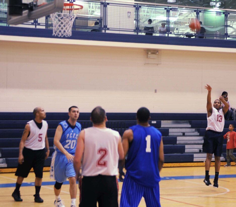 Matt Spriggs, 497th Intelligence, Reconnaissance and Surveillance Group, shoots from the three-point line in a game against the Combat Targeting and Intelligence Group Team at the Shellbank Fitness Center Feb. 4. CTIG won the game 46-22. (U.S. Air Force photo/Airman 1st Class Jason J. Brown)