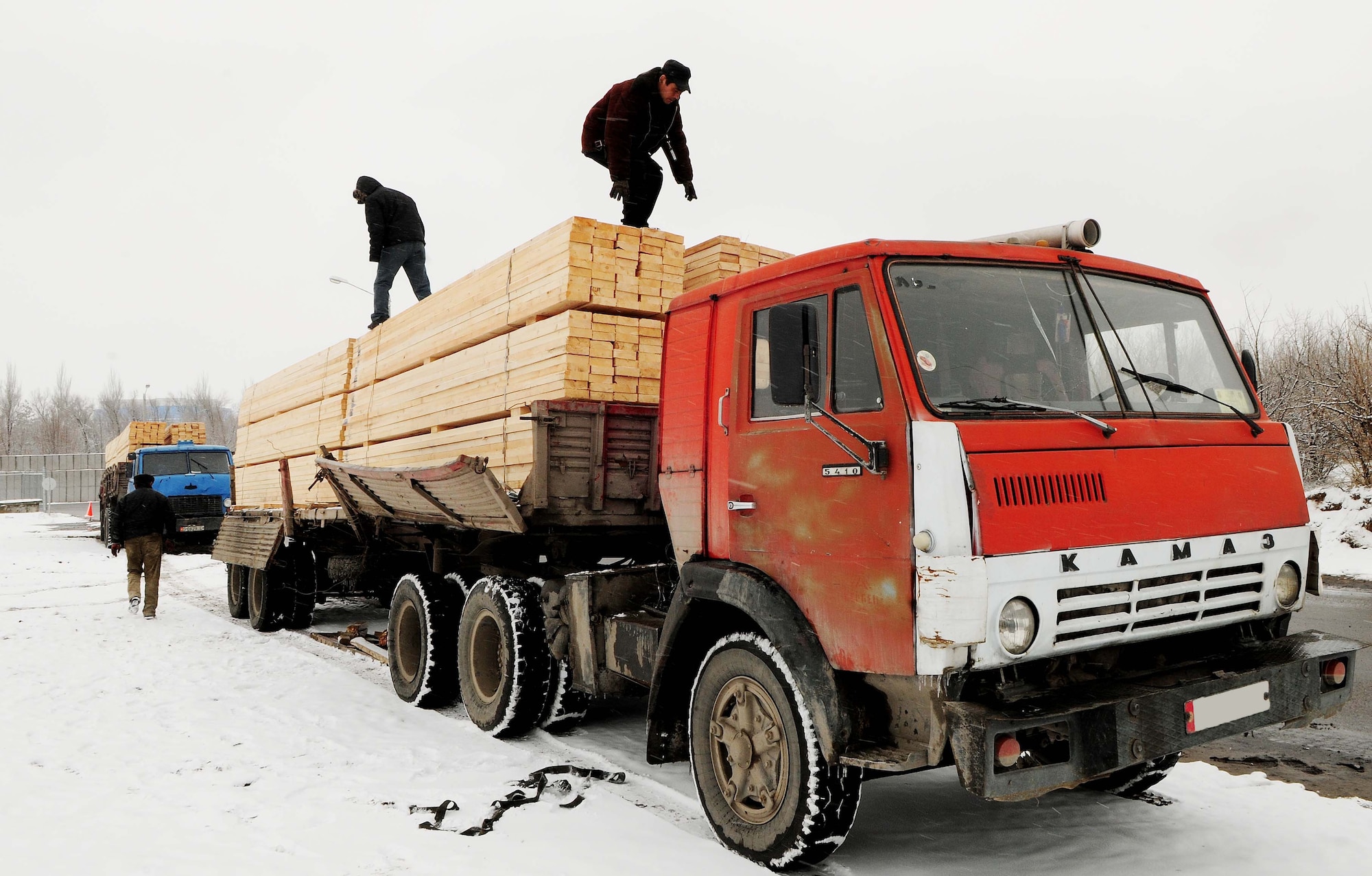 Members of a local Kyrgyz lumber supplier prepare their entire stock of wood for unloading onto the Transit Center at Manas, Kyrgyzstan, Feb 3, 2010. The 376th Expeditionary Contracting Squadron here purchased more than 13,000 pieces of lumber to ship to Afghanistan for base buildup. This massive transfer will boost the local economy and help coalition forces downrange. The project was made possible through the collaborative efforts of contracting, security forces, civil engineers, aerial porters, logistics, and many other support agencies on the Transit Center. Look for an upcoming story on the start-to-finish process. (U.S. Air Force photo/Senior Airman Nichelle Anderson/released)