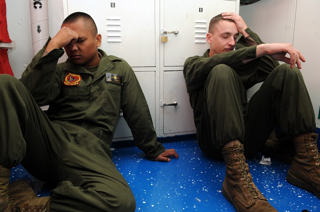 Lance Cpl. Mark Ridoloso, left, and Lance Cpl. William Jahn, Marine Attack Squadron 311 powerline mechanics, take a moment to calm their seasick stomachs aboard the USS Peleliu as the ship begins to rock while it pulls away from the San Diego coastline Feb. 8, 2010. Approximately 10 pilots and 15 support and maintenance personnel participated in the exercise. The squadron practiced Harrier operations aboard the aircraft carrier from Feb. 8-11, including night flights, in preparation for the squadron’s upcoming deployment aboard the Peleliu with the 15th Marine Expeditionary Unit in May. “It’s a bit of a culture shock,” said Ridoloso, who had never been aboard a Navy ship before this. “When we first stepped onto the boat, I could feel it rocking, which made me kind of seasick, but I got used to it.”