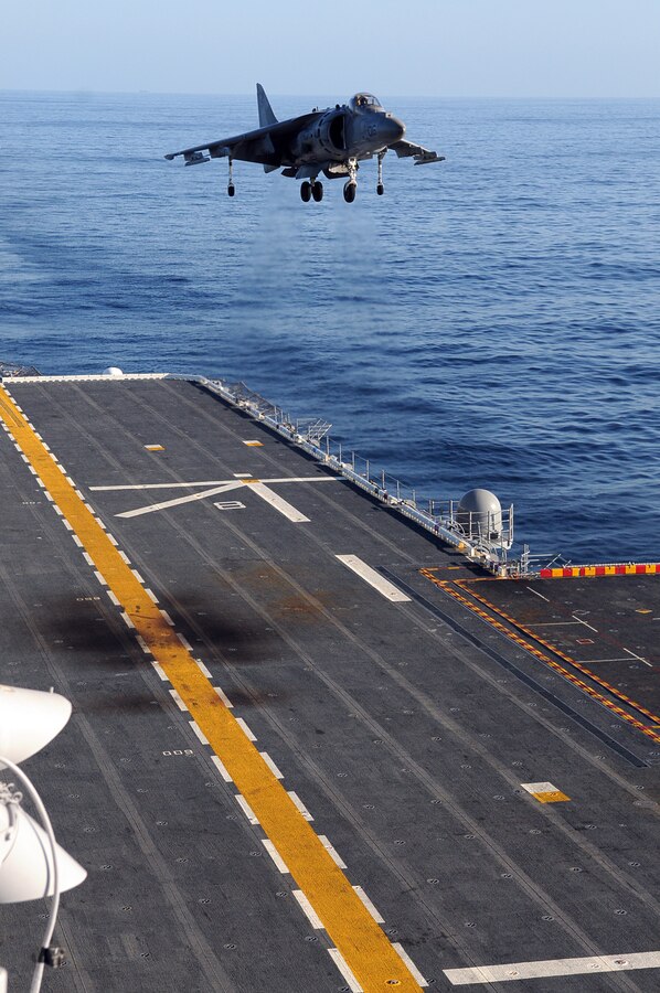 Capt. Michael Cassidy, Marine Attack Squadron 311 pilot, lands vertically on the flight deck of the USS Peleliu Feb. 8, 2010 during the squadron's aircraft carrier qualifications. Approximately 10 pilots and 15 support and maintenance personnel participated in the exercise. The squadron practiced Harrier operations aboard the aircraft carrier from Feb. 8-11, including night flights, in preparation for the squadron’s upcoming deployment aboard the Peleliu with the 15th Marine Expeditionary in May. “Trying to land on something that’s constantly moving is always more difficult,” said Capt. Eric Fong, squadron pilot. "It's good to get all this practice in."