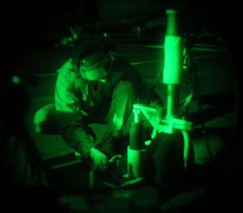 Sgt. Dustin Sholl, Marine Attack Squadron 311 powerline mechanic, changes a tire on an AV-8B Harrier at night on the flight deck of the USS Peleliu Feb. 8, 2010. The ship’s deck has a very rough texture that is designed to prevent skidding. “On it, tires wear twice as fast. It’s not uncommon to change tires often during ship operations,” said Sholl, who has deployed aboard ship twice. The squadron trained aboard the Peleliu for a week in order to obtain its aircraft carrier qualifications and prepare for its upcoming deployment with the 15th Marine Expeditionary in May. Approximately 10 pilots and 15 support and maintenance personnel participated in the exercise. The squadron practiced Harrier operations aboard the aircraft carrier from Feb. 8-11, including night flights, in preparation for the squadron’s upcoming deployment aboard the Peleliu.