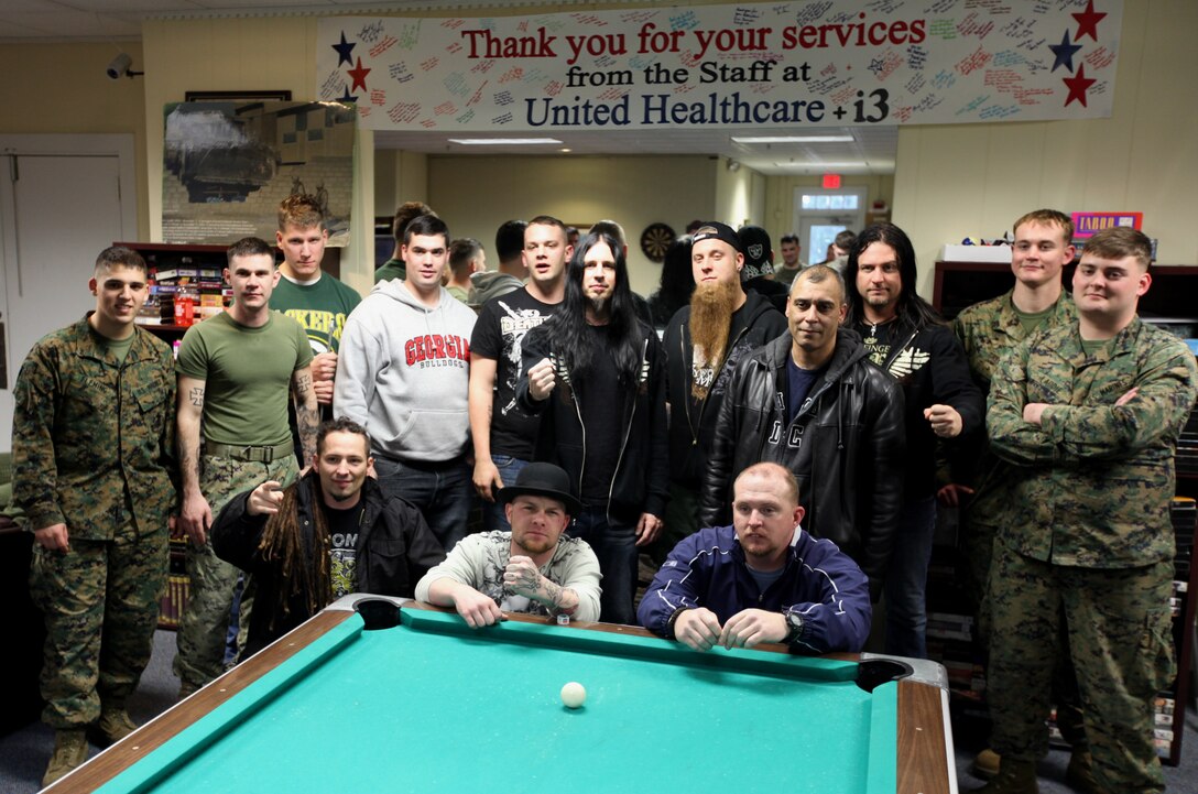 Several members of the Wounded Warrior Battalion-East pose with the band Five Finger Death Punch during a visit to the battalion Feb. 9. This was the second visit the band has made with the battalion.