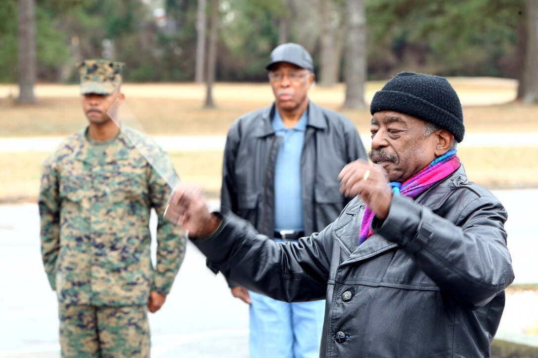 Retired 1st Lt. Tony Mosely, the first African American band officer, conducts the 2nd Marine Division Band in playing the Marines' Hymn Feb. 9 in the Paradise Point Golf Course parking lot aboard Camp Lejeune.