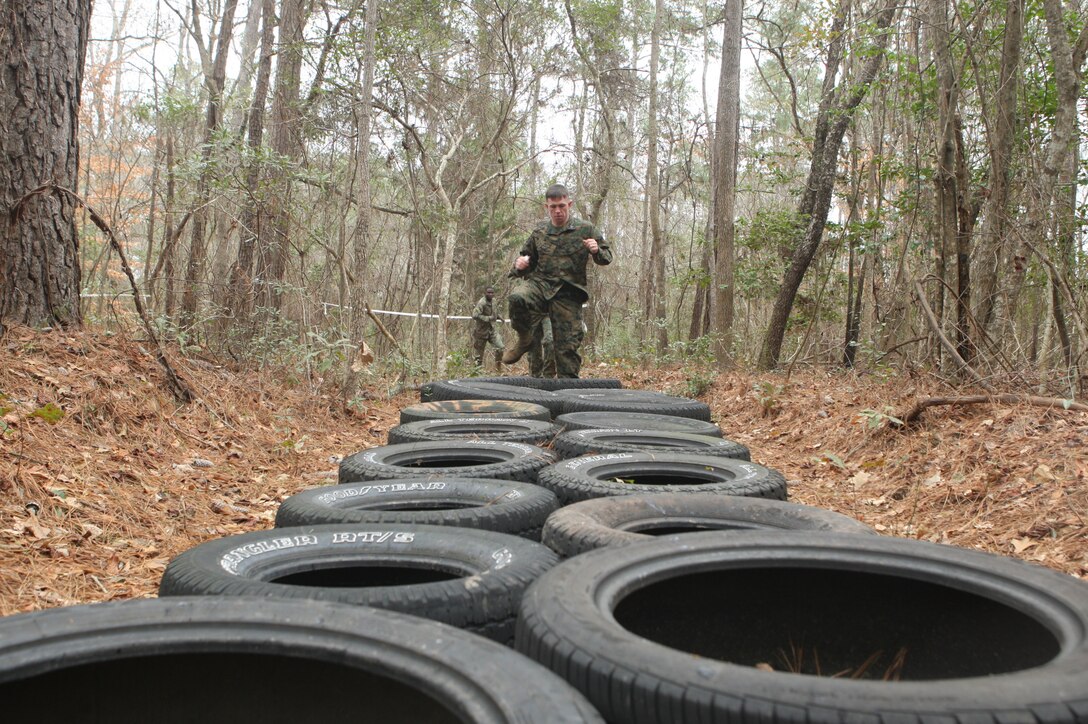 MARINE CORPS BASE CAMP LEJEUNE, N.C. -- Sgt. James Arvin, platoon sergeant with Brig Co, Headquarters and Support Battalion, Marine Corps Base Camp Lejeune leads a squad of corporals through one of many obstacles during the Corporals Stamina Course aboard Stone Bay, Feb. 9. (Marine Corps photo by Lance Cpl. Jonathan G. Wright)