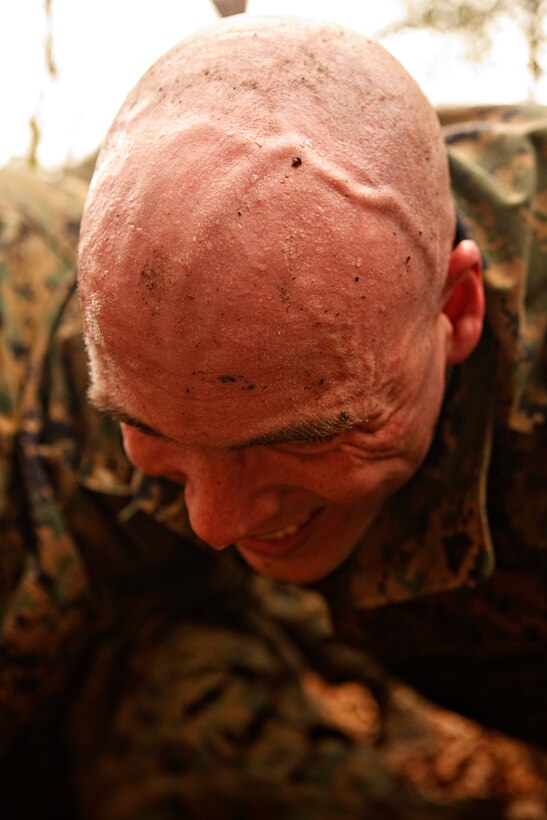 MARINE CORPS BASE CAMP LEJEUNE, N.C. – A corporal with Headquarters and Support Battalion, Marine Corps Base Camp Lejeune stresses while 'building a house' during the Corporals Stamina Course aboard Stone Bay, Feb. 9. (Marine Corps photo by Lance Cpl. Jonathan G. Wright)