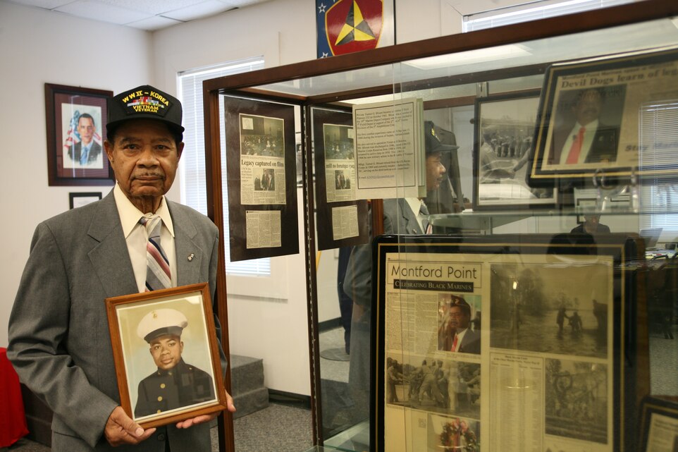 Turner G. Blount, one of the first African-Americans in the Marine Corps, holds his boot camp graduation photo. Blount was drafted into the Marines in 1943 where he served in three wars: World War II, the Korean War and the Vietnam War. He retired in 1969 as a master sergeant and went on to become a councilman for the city of Jacksonville, N.C.